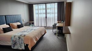 a hotel room with a bed and a desk and a window at Hotel styling entire one bedroom in Sydney +39 photos