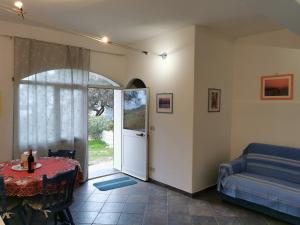 a living room with a table and a couch at Villa Pierina in Finale Ligure