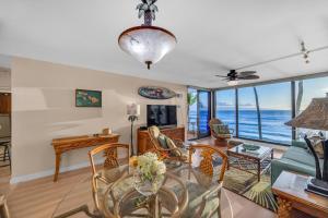 a living room with a view of the ocean at Mahana 305 in Kahana +23 photos