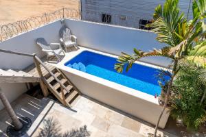 a swimming pool sitting next to a house at Casa cerro in Puerto Escondido