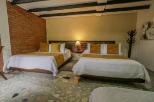 Postel nebo postele na pokoji v ubytování Hotel Vísperas