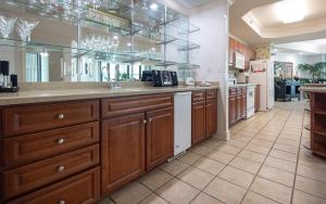 a large kitchen with wooden cabinets and a large mirror at Lighthouse on the Bay 2311 condo in Orange Beach
