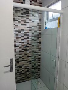 a bathroom with a shower with a glass door at Encantos do Natal em Garanhuns in Garanhuns +6 photos