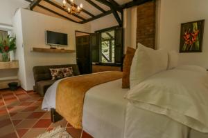 Postel nebo postele na pokoji v ubytování Hotel Vísperas