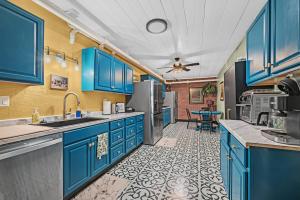a blue kitchen with blue cabinets and a table at The Extraordinary Camino Hotel in Camino +30 photos