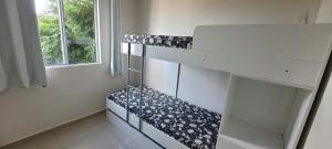 a white shelf in a room with a window at Apartamento - Básico Sossego in Porto Alegre
