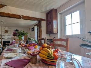a table with a bowl of fruit on it at Chambres d'hôtes au calme près des châteaux de la Loire - FR-1-591-664 in Châtillon-sur-Indre