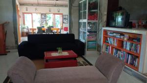 a living room with a couch and a table at Banua Lida Homestay in Poso