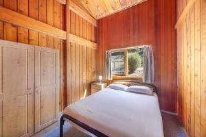 a small bedroom with a bed and a window at Reflections Burrinjuck Waters - Holiday Park in Bookham