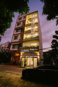 a tall building with a sign in front of it at Chingu Boutique Vũng Tàu in Vung Tau