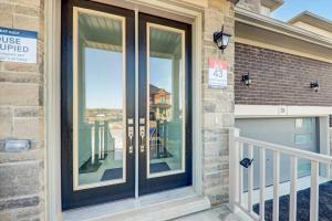 a home with a glass door with a balcony at Detached New Modern House In South Barrie - Built H plus ME Technology in Barrie