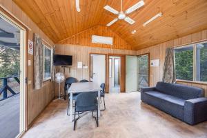 a living room with a couch and a table at Reflections Burrinjuck Waters - Holiday Park in Bookham