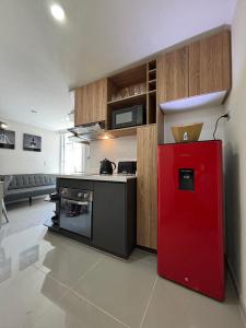 a kitchen with a red refrigerator in a room at A pasos del metro Steps away from the subway in Santiago
