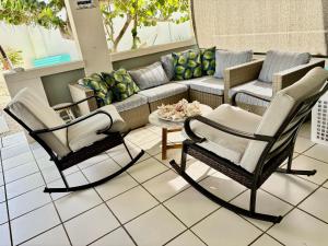 two chairs and a couch on a patio at Fantastic Private Tropical Villa in Palm Beach with Breakfast in Palm-Eagle Beach