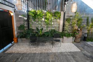 un patio con 2 sedie e un tavolo con piante di Trăng Non Homestay a Phan Thiet Altre 15 foto