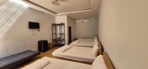 a small room with two beds and a tv at Mobile Home Ho Tram Pristine Beach in Thuận Biên
