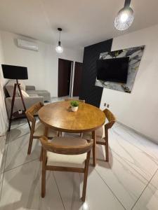 a living room with a wooden table and chairs at Torres del Mar in Manzanillo