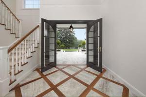 a hallway with an open door to a yard at Treehaven Estate - A Luxe Nature Escape with Pool in Maleny