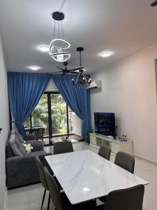 a living room with a table and a couch at Pool View 3 Bedroom & 3 Bathroom Whole Unit in Johor Bahru