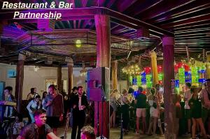 a crowd of people standing in a room with lights at M'pai Bay Hotel in Koh Rong Sanloem