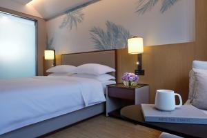 Postel nebo postele na pokoji v ubytování Sanya Han's Grace Hotel