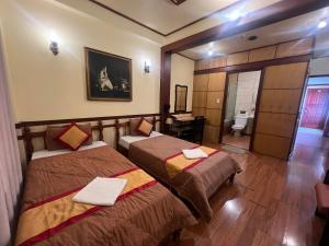 Postel nebo postele na pokoji v ubytování BI SAIGON Hotel - BUI VIEN WALKING STREET