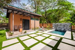 a backyard with a pool and a house at 2 Nature Villas with Pool in Santa Cruz