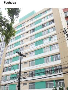 a tall building with a street light in front of it at Apartamento inteiro 2 quartos Porto Barra Vista Mar in Salvador