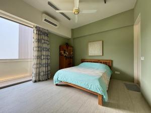 a bedroom with a bed and a ceiling fan at By The Sea Batu Ferringhi, Penang Beach in Batu Ferringhi +40 photos
