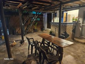 a wooden table and chairs in a room at Hugo's Place in Taganga