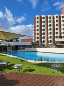 a swimming pool in front of a large building at Residence on Langley Park in Perth