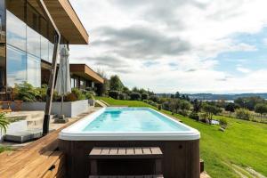 a swimming pool in the backyard of a house at Luxury House Altamira Grill Jacuzzi Pool in Villarrica