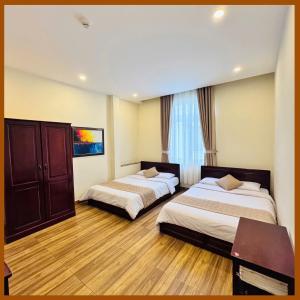 Postel nebo postele na pokoji v ubytování Nam Xuan Premium Hotel