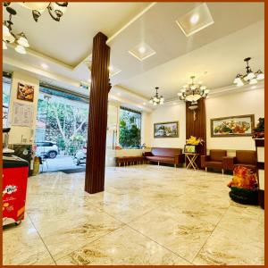a lobby with a pillar in the middle of a room at Nam Xuan Premium Hotel in Da Lat