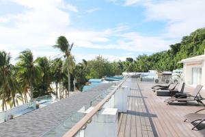 a deck with chairs and trees on a house at The Muse Hotel Boracay in Boracay