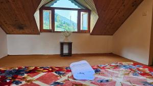 a bedroom with a large bed with a large window at Khwabgaah Manali in Manāli +7 photos