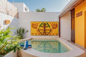a swimming pool in the side of a building at Casa Tolok in Mérida