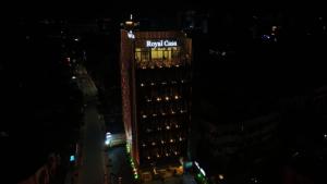 a tall building with a sign on it at night at Royal Casa Cochin in Cochin +64 photos