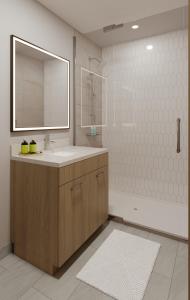 a bathroom with a sink and a mirror and a tub at Brand New Mountain Retreat! in Canmore