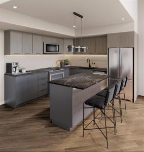 a kitchen with a large island with bar stools at Brand New Mountain Retreat! in Canmore