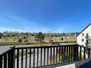 a balcony with a view of a park at Magnifique appartement avec mezzanine prés Thalasso in Cabourg +13 photos