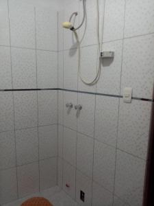 a bathroom with a shower with a shower head at Hostal Aylluq Wasin - Guest House-Casa de Familia in Urubamba