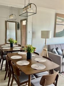 a dining room with a table with chairs and a couch at 2Br QC Furnished Condo w 300mbps Net Free Pool Use in Manila