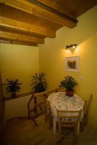 a dining room with a table and two potted plants at Rooms Roza in Slunj +17 photos