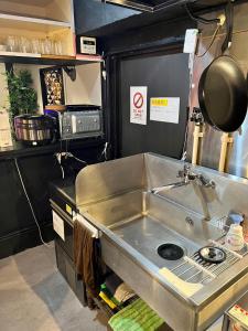 a kitchen with a sink and a stove at 飲み放題カラオケお菓子食べ放題付元飲食店のエンターテイメント物件大人数可天神駅徒歩5分 in Fukuoka +53 photos