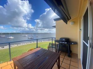 a balcony with a table and a view of the water at Riverview Apartment 2.6 3-5 Riverview Street in Iluka