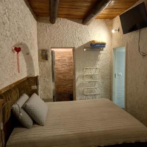 Posteľ alebo postele v izbe v ubytovaní La Grotta