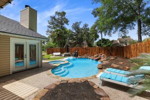 a swimming pool in a yard with a fence at Woodbridge Bungalow - Private Villa Near IAH - Pool in Houston