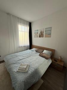 a bedroom with a bed with two towels on it at Modern Living - Im Grund in Spaichingen