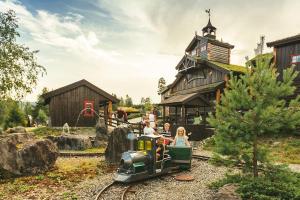 a group of people riding a small train on the tracks at Leilighet i Lillehammer med gratis parkering in Lillehammer